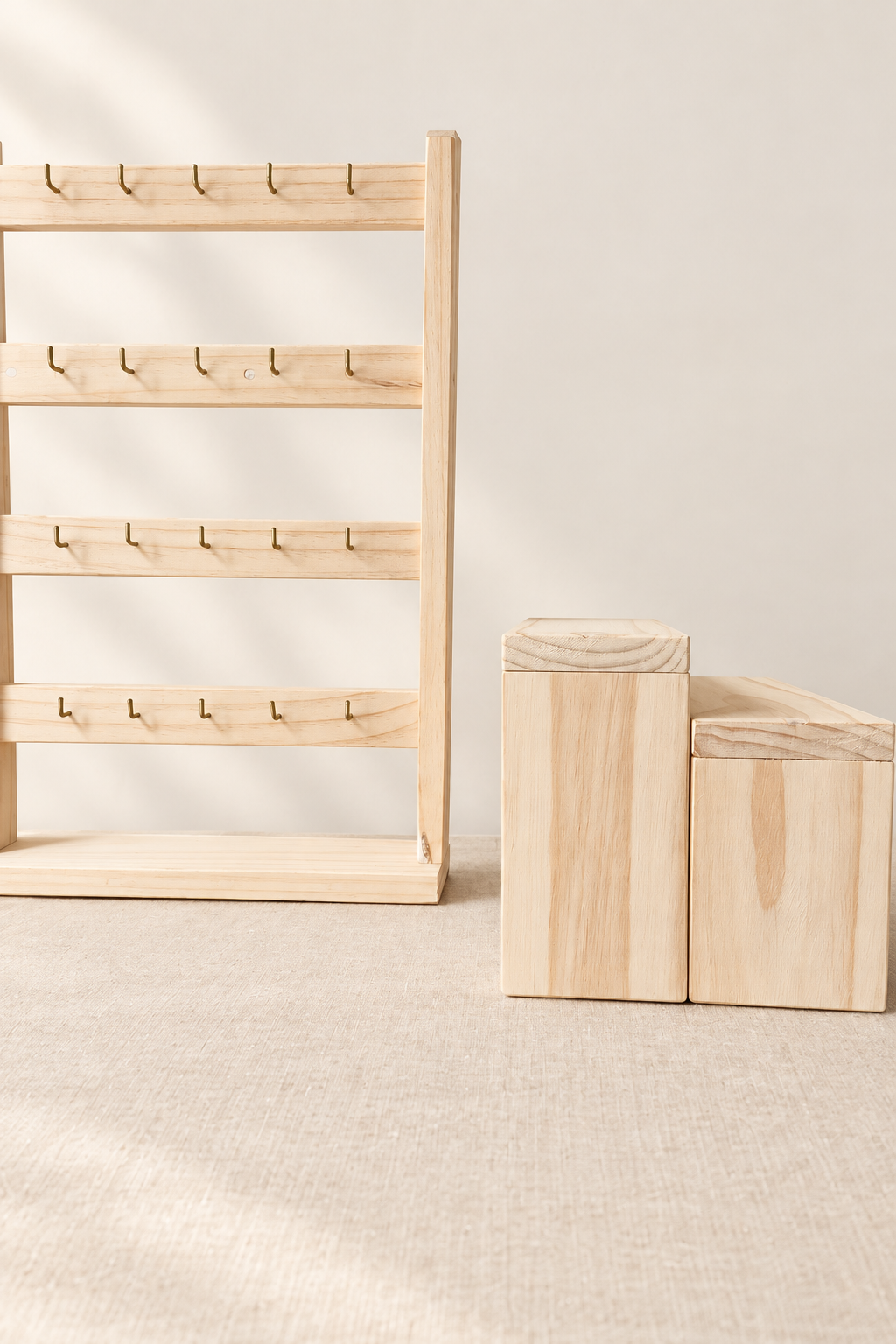 Organizador de madera con ganchos y dos cajas, fondo blanco cálido